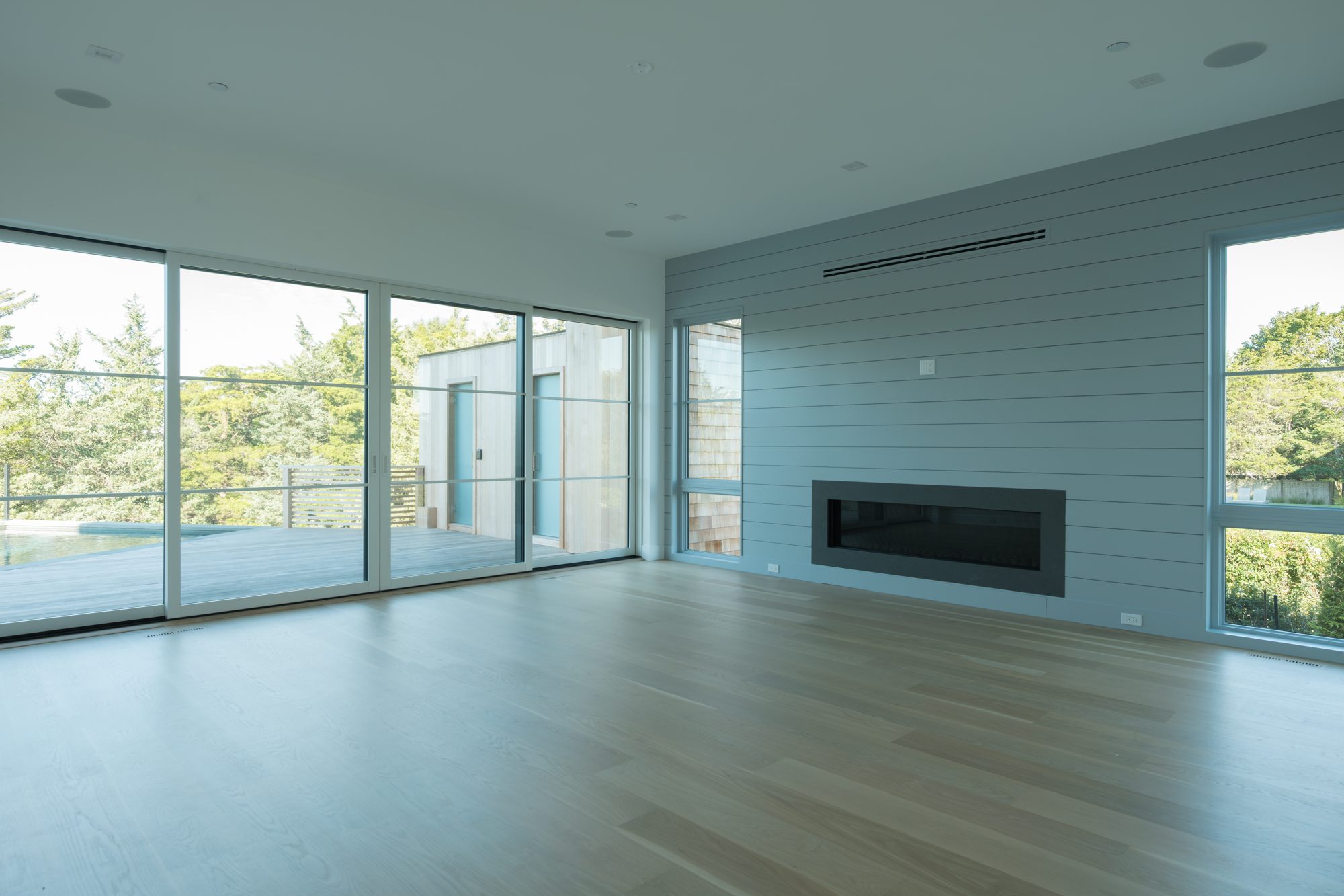 Living room with white oak floors and linear fireplace